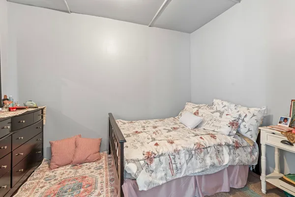 a bedroom with a bed and a couch