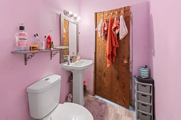 a bathroom with a toilet sink and shower curtain