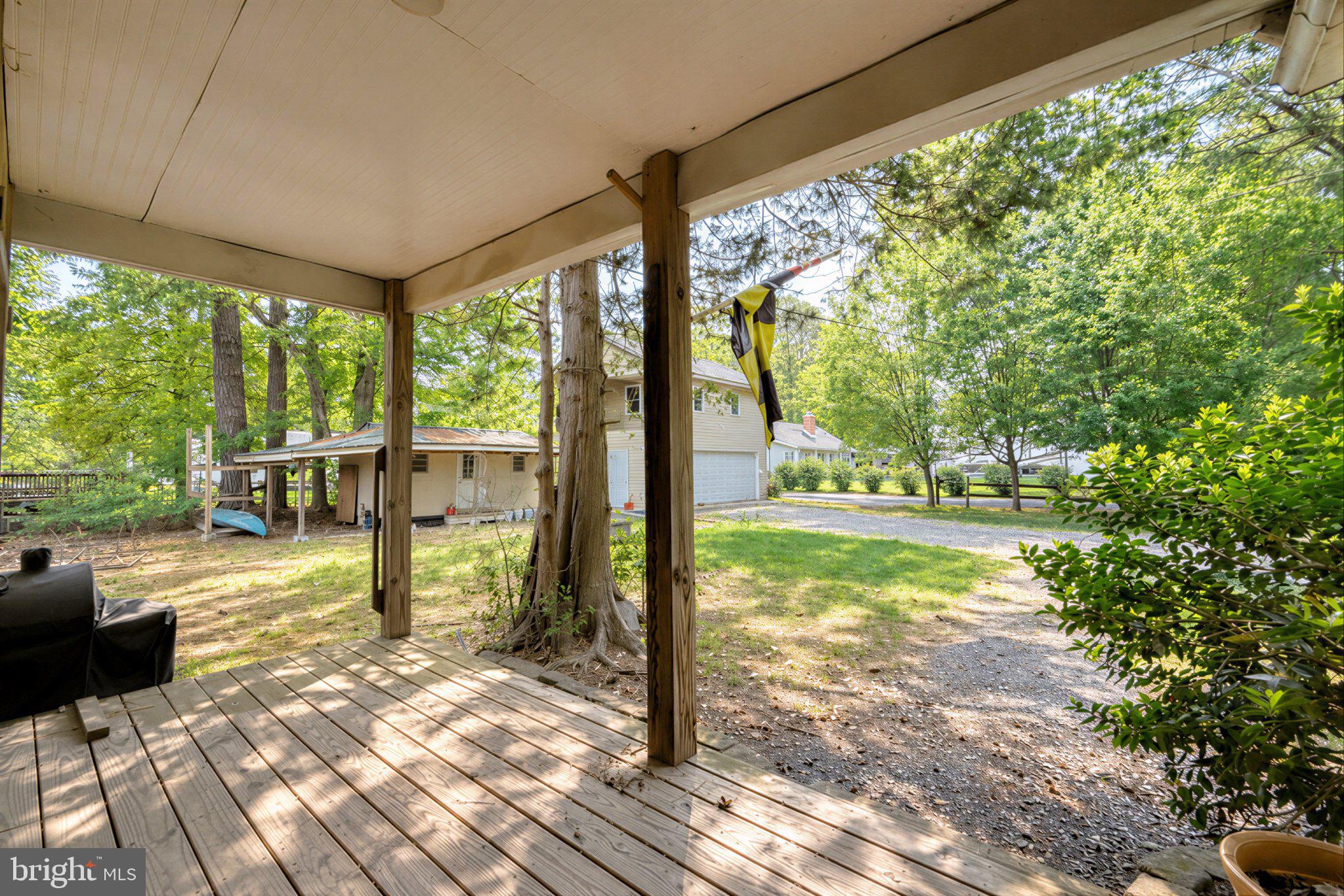 42195 White Point Beach Road Leonardtown, MD 20650 - Photo 12 of 57 Serene porch view in lush surroundings.
