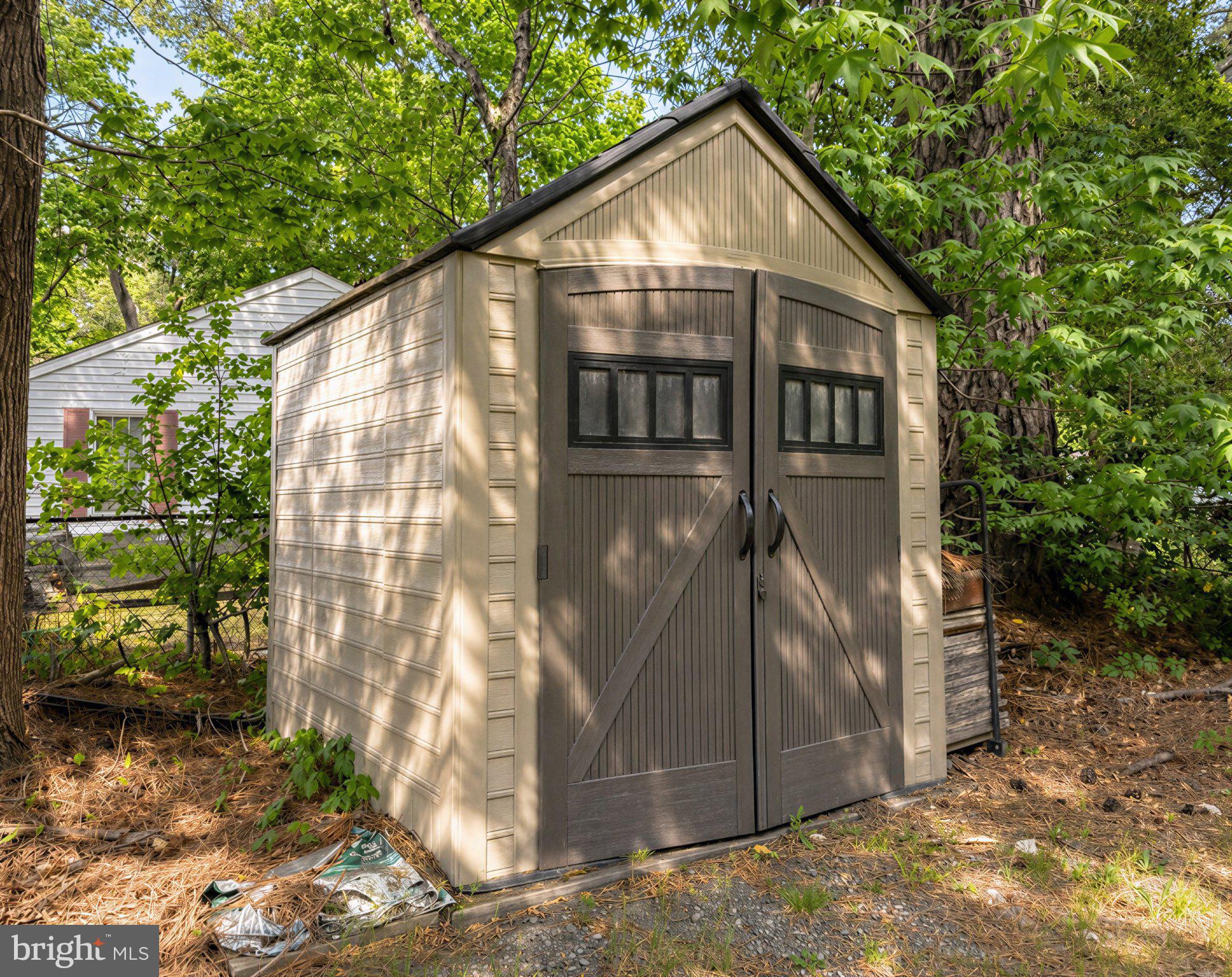 42195 White Point Beach Road Leonardtown, MD 20650 - Photo 17 of 57 Charming garden shed nestled in greenery.