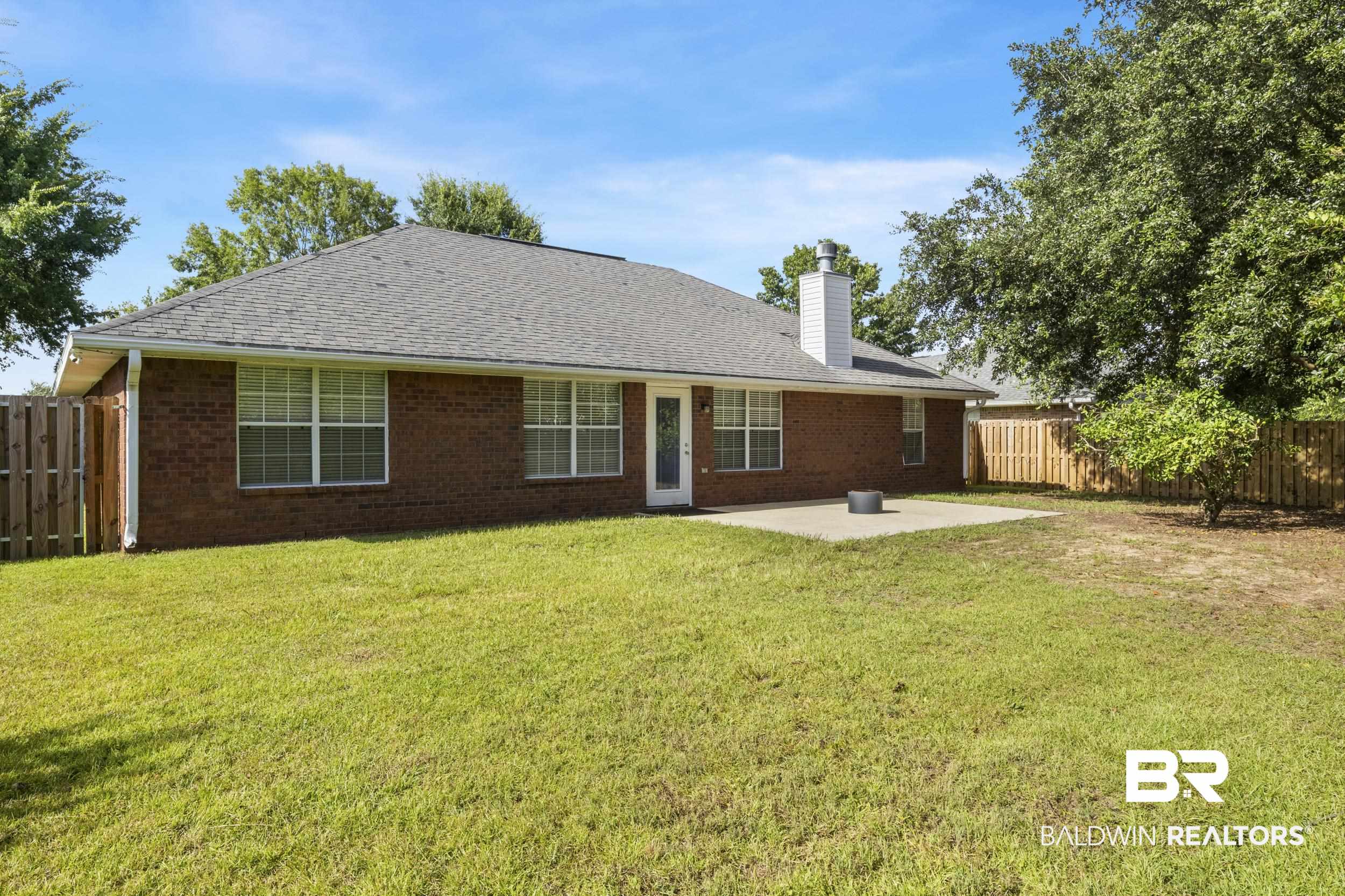9610 Watkins Drive Fairhope, AL 36532 - Photo 21 of 26 Back of house featuring a patio and a yard