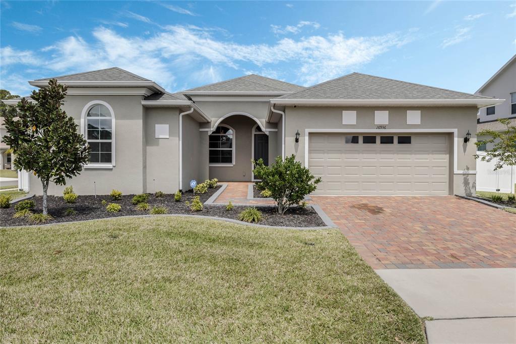 a front view of a house with a yard