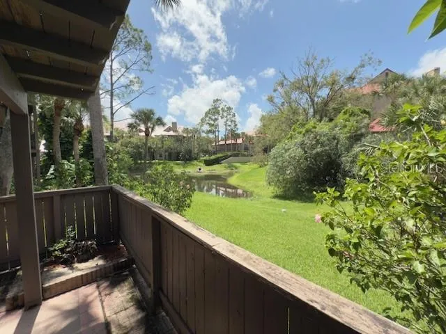 a view of a wooden floor and a yard in back