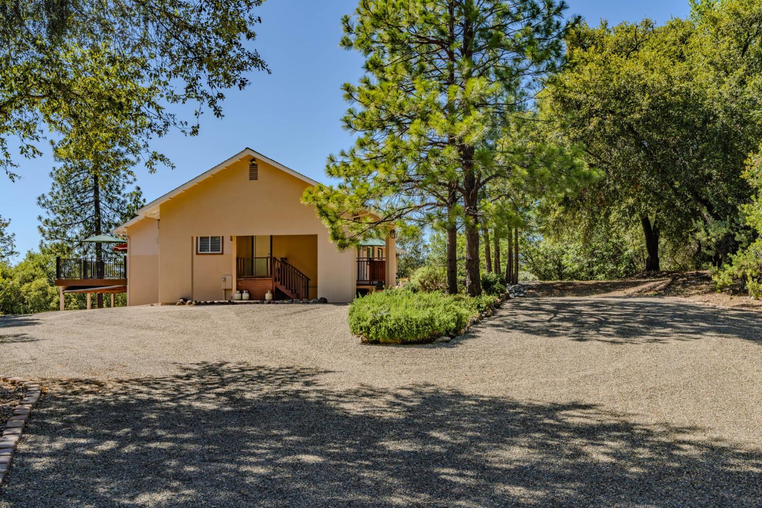 18299 West Clinton Road Jackson, CA 95642 - Photo 4 of 56 a front view of a house with a yard and garage