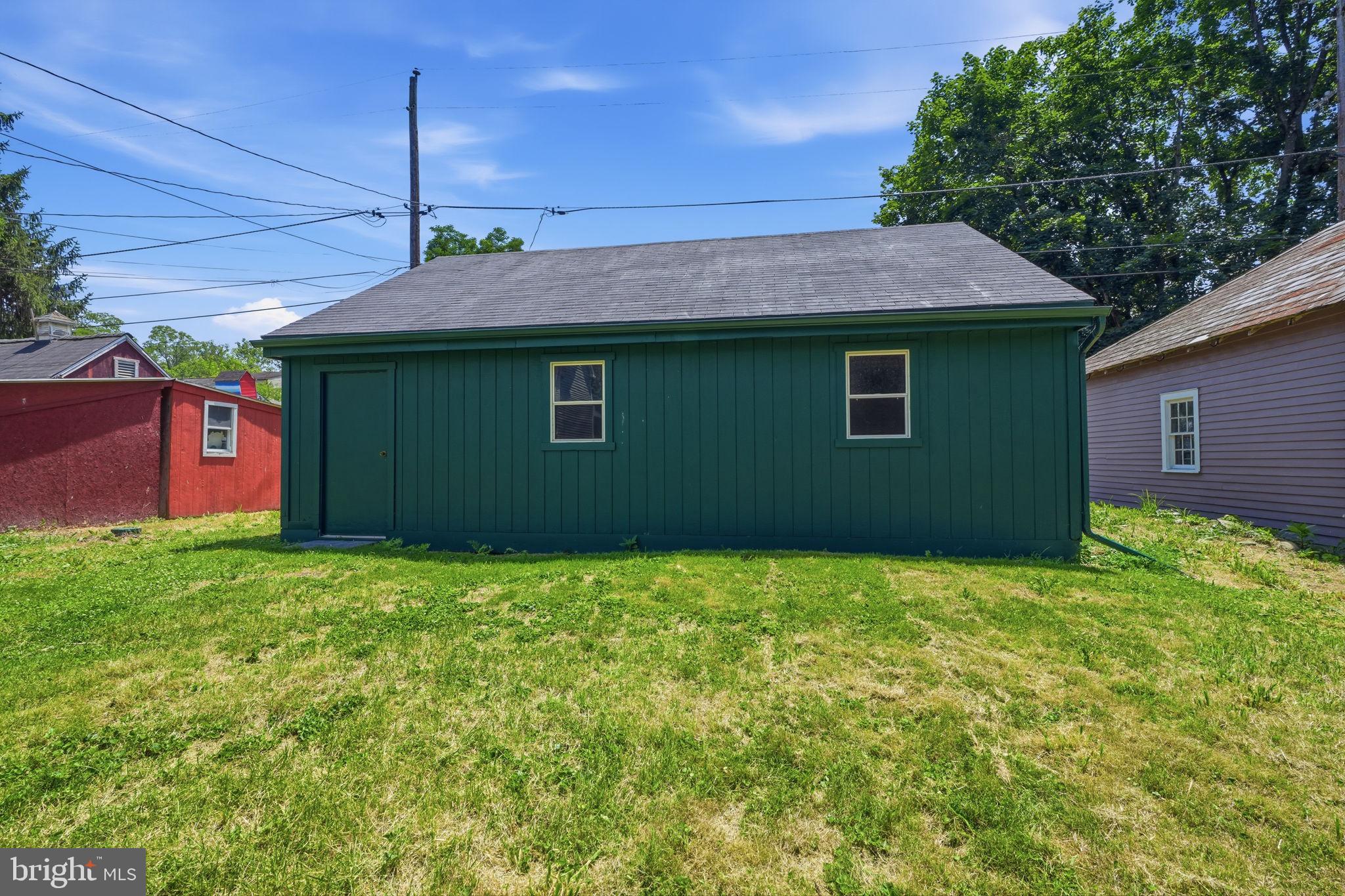 124 Cedar Road Riegelsville, PA 18077 - Photo 43 of 50 Charming green shed in a sunny yard.