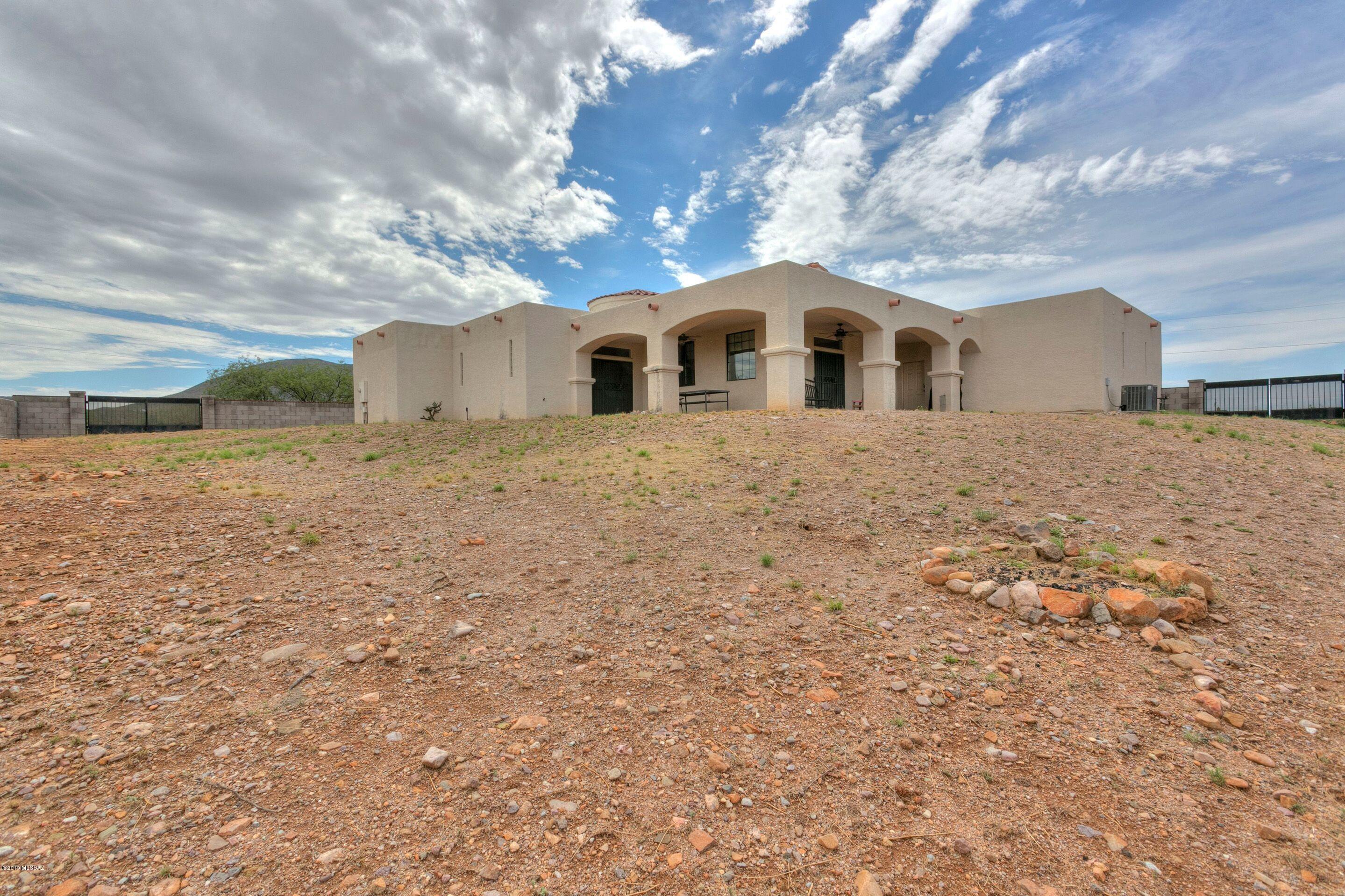 1648 Circulo Puerto Rio Rico, AZ 85648 - Photo 1 of 34 a front view of a house with a yard