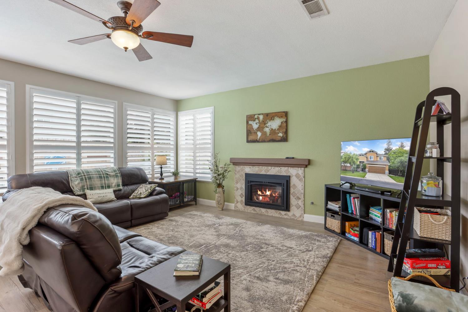 3755 Canyonlands Road Stockton, CA 95209 - Photo 11 of 37 a living room with furniture a bookshelf and a fireplace