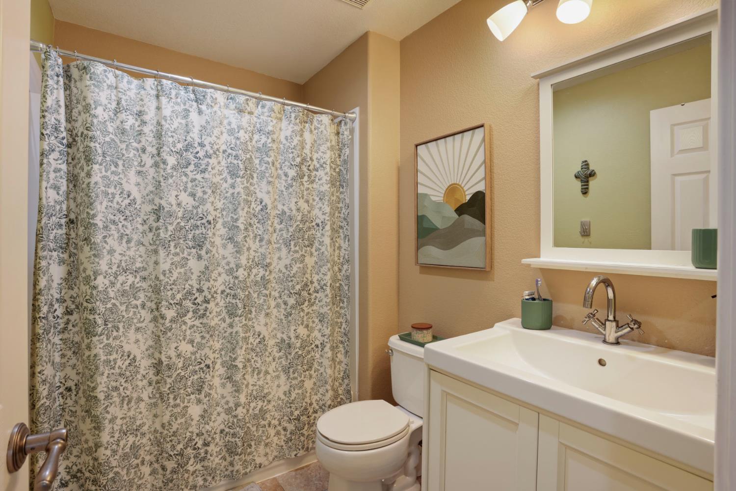3755 Canyonlands Road Stockton, CA 95209 - Photo 16 of 37 a bathroom with a sink and a mirror