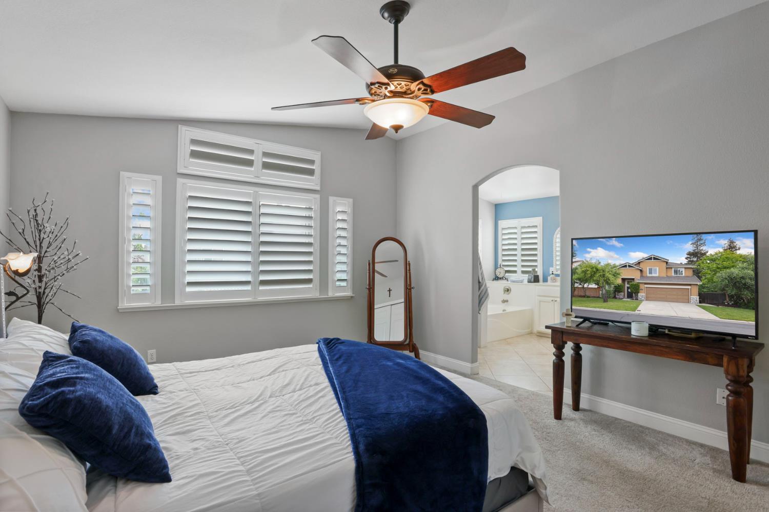 3755 Canyonlands Road Stockton, CA 95209 - Photo 21 of 37 a bedroom with a bed and a flat screen tv