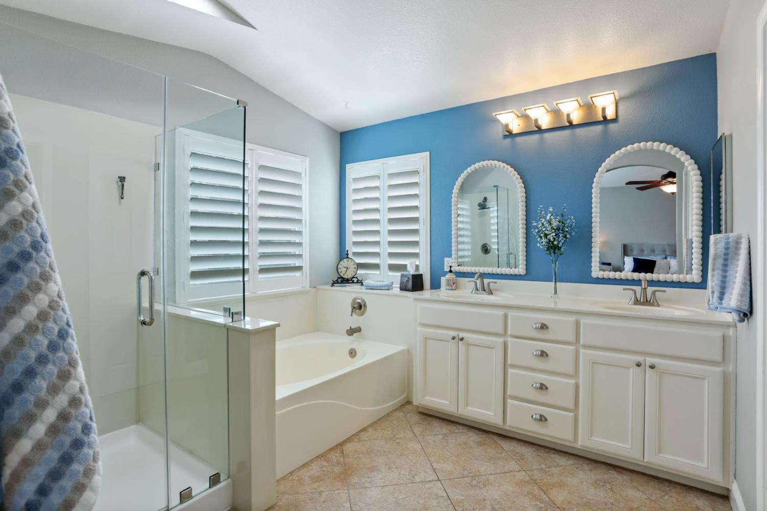 3755 Canyonlands Road Stockton, CA 95209 - Photo 23 of 37 a spacious bathroom with a double vanity sink a large mirror and a bathtub