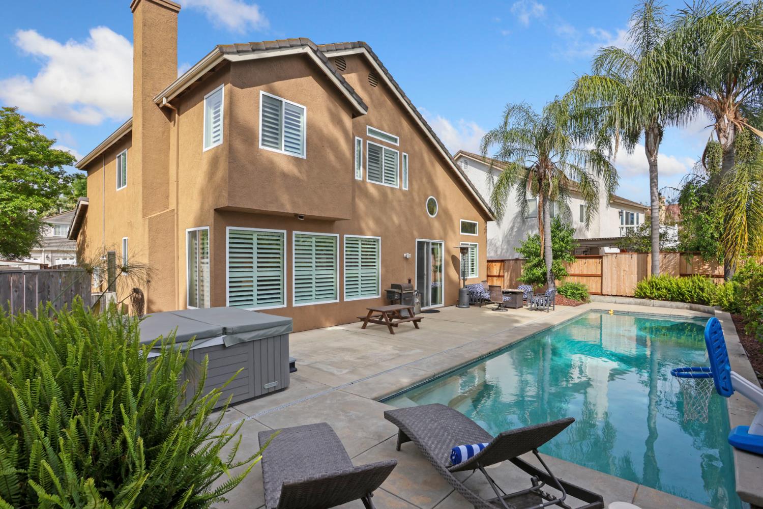 3755 Canyonlands Road Stockton, CA 95209 - Photo 28 of 37 a backyard of a house with barbeque oven table and chairs