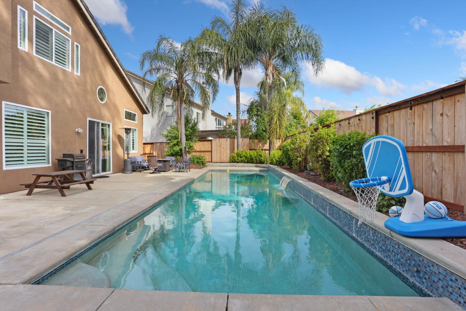 3755 Canyonlands Road Stockton, CA 95209 - Photo 29 of 37 a view of a swimming pool with chairs