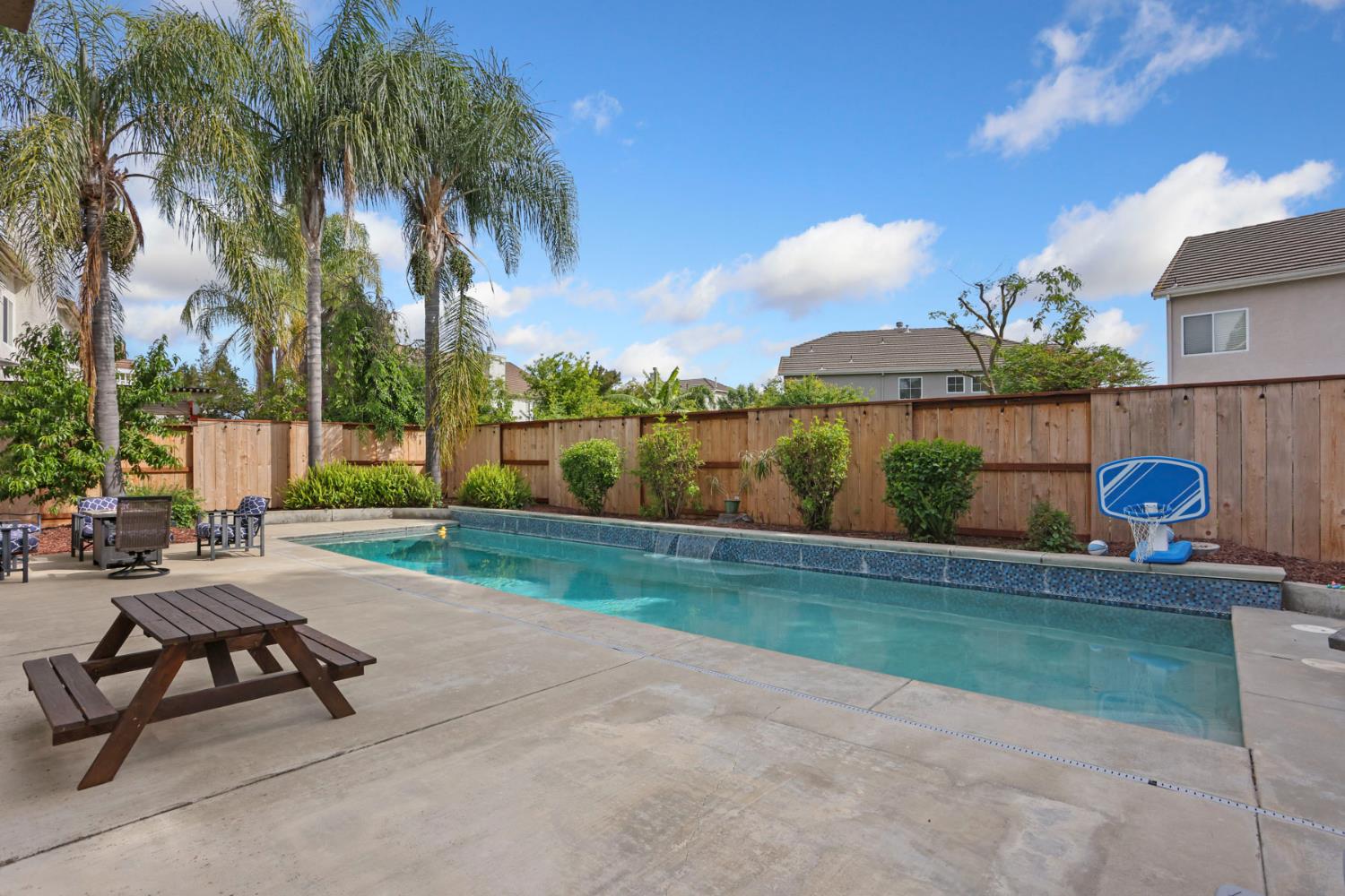 3755 Canyonlands Road Stockton, CA 95209 - Photo 33 of 37 a view of a patio with a table and chairs under an umbrella