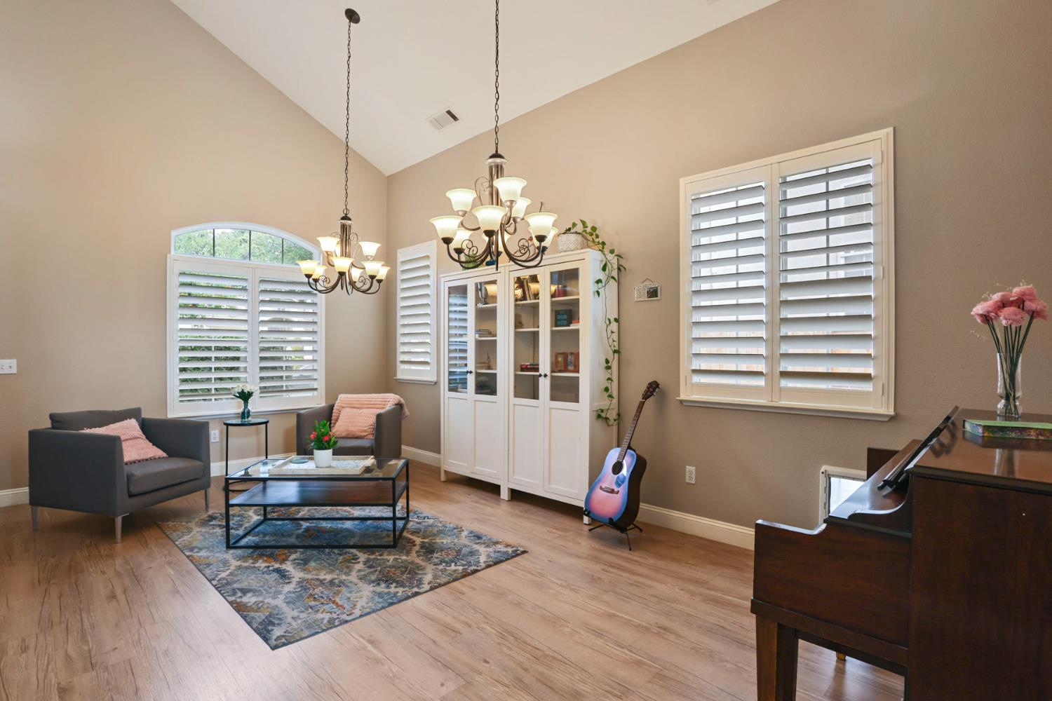 3755 Canyonlands Road Stockton, CA 95209 - Photo 4 of 37 a living room with furniture and a chandelier