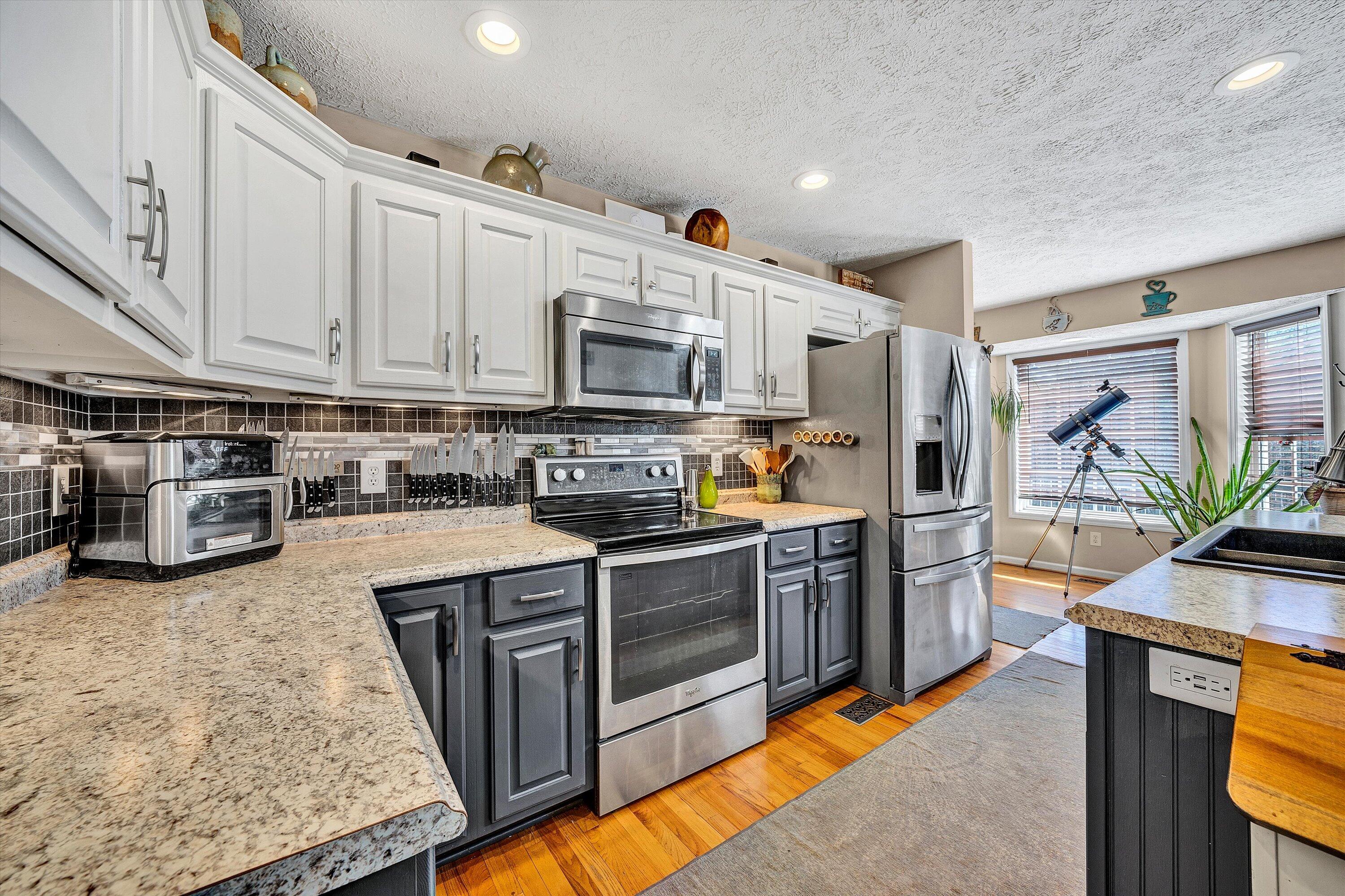 1422 Isolane Road Callaway, VA 24067 - Photo 13 of 39 a kitchen with stainless steel appliances granite countertop a stove top oven a sink dishwasher and a refrigerator
