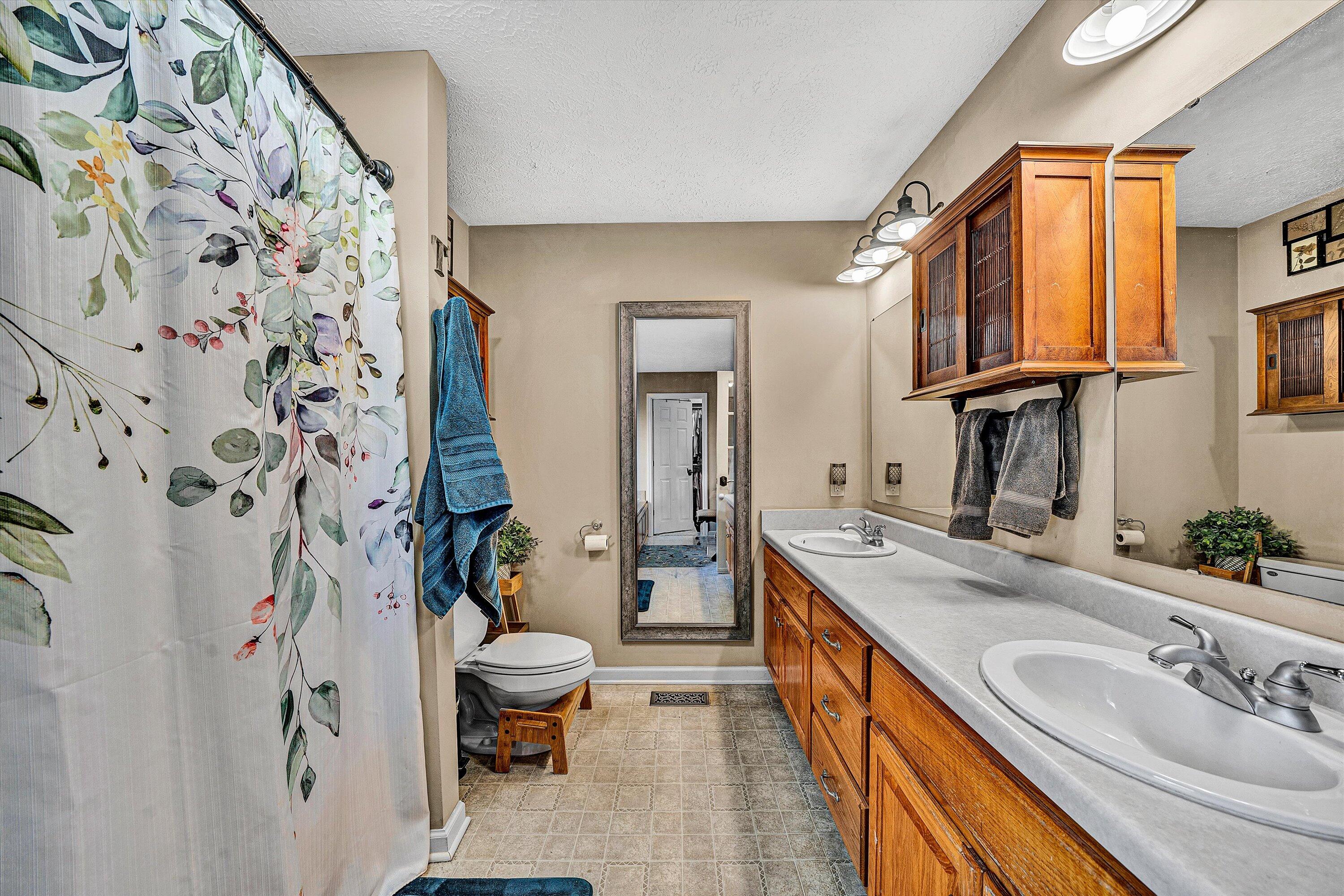 1422 Isolane Road Callaway, VA 24067 - Photo 23 of 39 a bathroom with a granite countertop sink and a large mirror