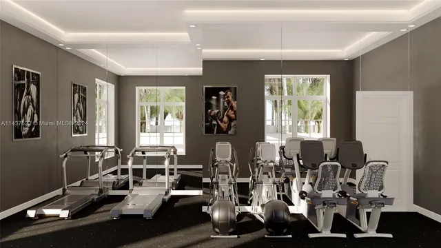 a room with gym equipment and large windows