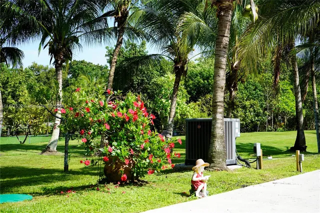 an aerial view of residential house with outdoor space and trees all around