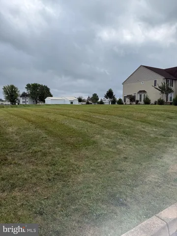 a view of house with outdoor space and garden