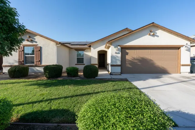 a front view of house with yard and green space
