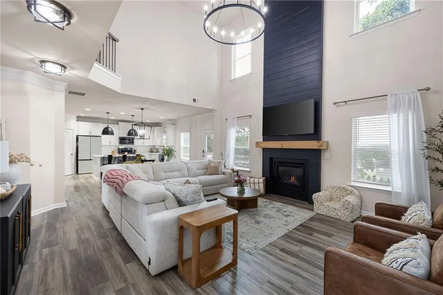 a living room with furniture mirror and a fireplace