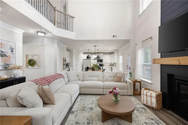 a living room with furniture a flat screen tv and a fireplace