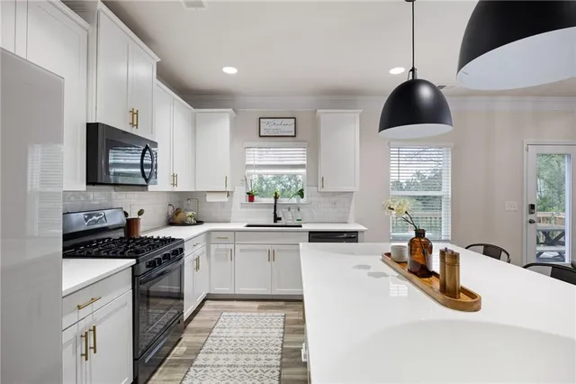 a bathroom with a sink a toilet and shower curtain