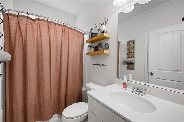 a white bath tub sitting next to a shower