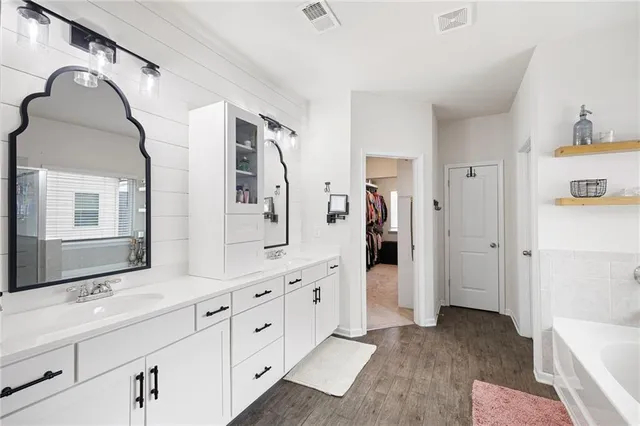 a bathroom with a sink a toilet and shower curtain