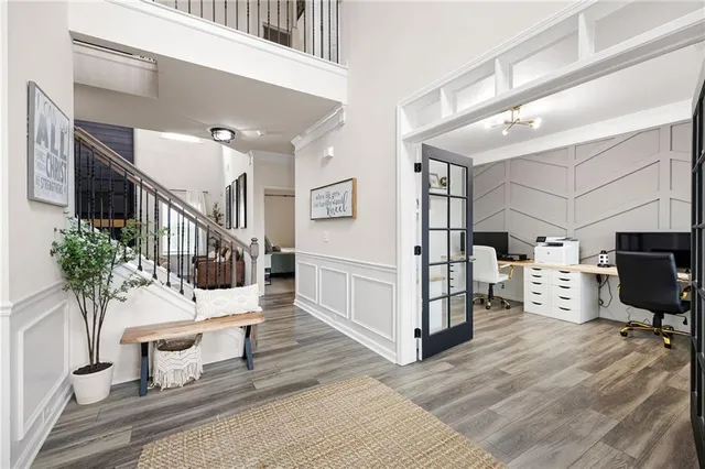 a living room with furniture a fireplace and a large window