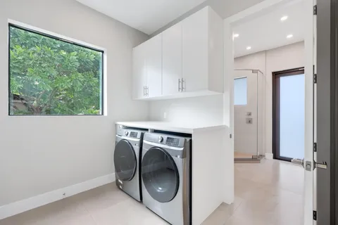 a bathroom with a double vanity sink and a mirror