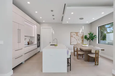 a kitchen with a sink refrigerator and cabinets
