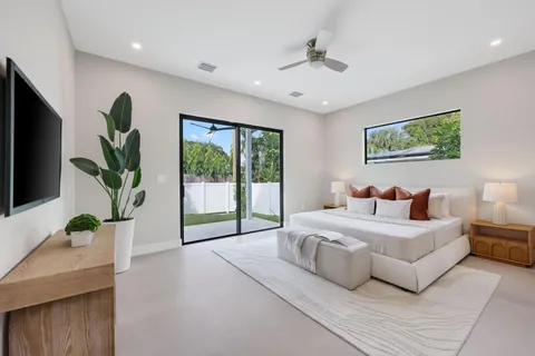 a bedroom with a bed and a television