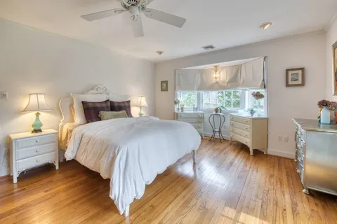 a spacious bedroom with a bed and a table