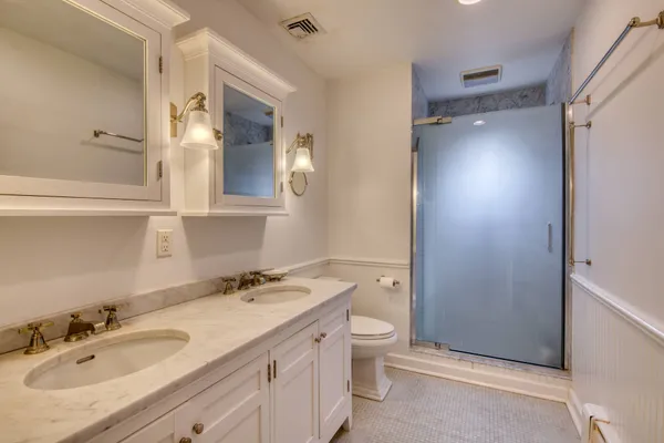 a bedroom with a bed and a flat tv screen on dresser