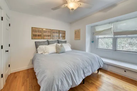 a bedroom with a bed and a large window