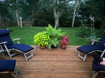 a view of a backyard with sitting area and bench