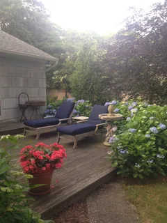 a view of a backyard with sitting area