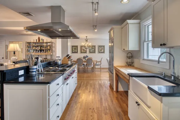 a view of a dining room with furniture wooden floor and chandelier