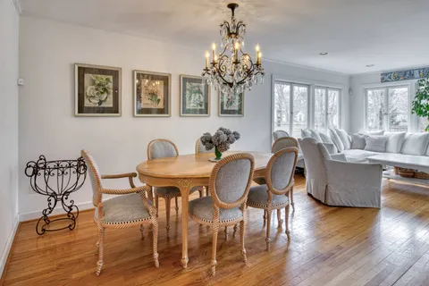 a view of a dining room with furniture wooden floor and chandelier