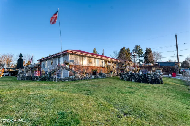 a view of a house with a yard and sitting space