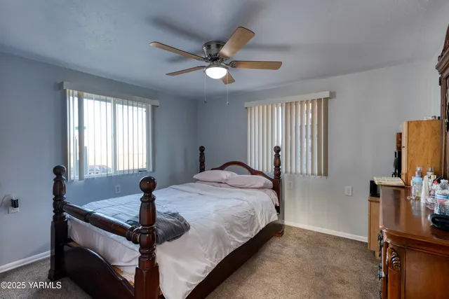 a bedroom with a bed and window with mirror