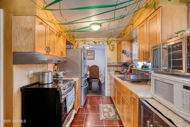 a kitchen with stainless steel appliances a stove and a refrigerator