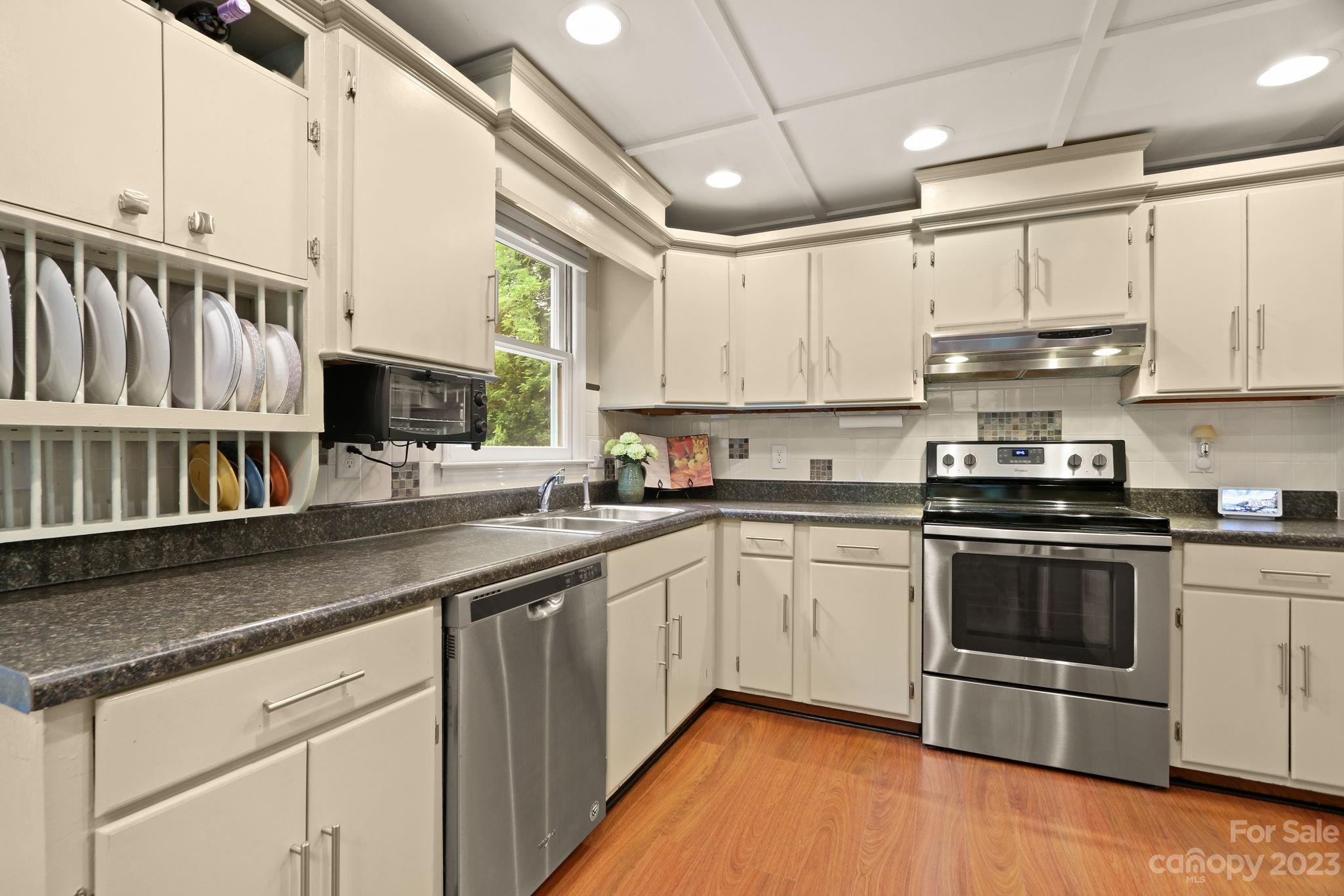 270 Pine Street Boone, NC 28607 - Photo 12 of 47 a kitchen with stainless steel appliances granite countertop a stove a sink and a microwave