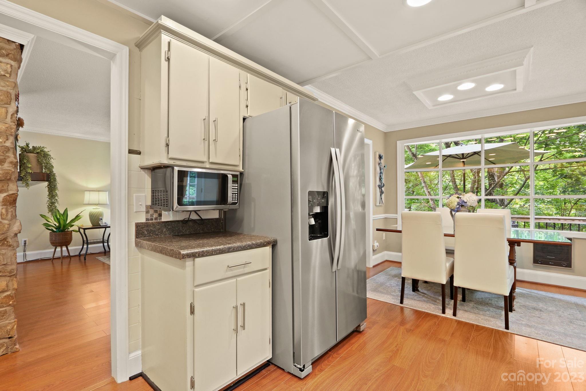 270 Pine Street Boone, NC 28607 - Photo 14 of 47 a kitchen with stainless steel appliances granite countertop a refrigerator a stove a dining table and chairs with wooden floor