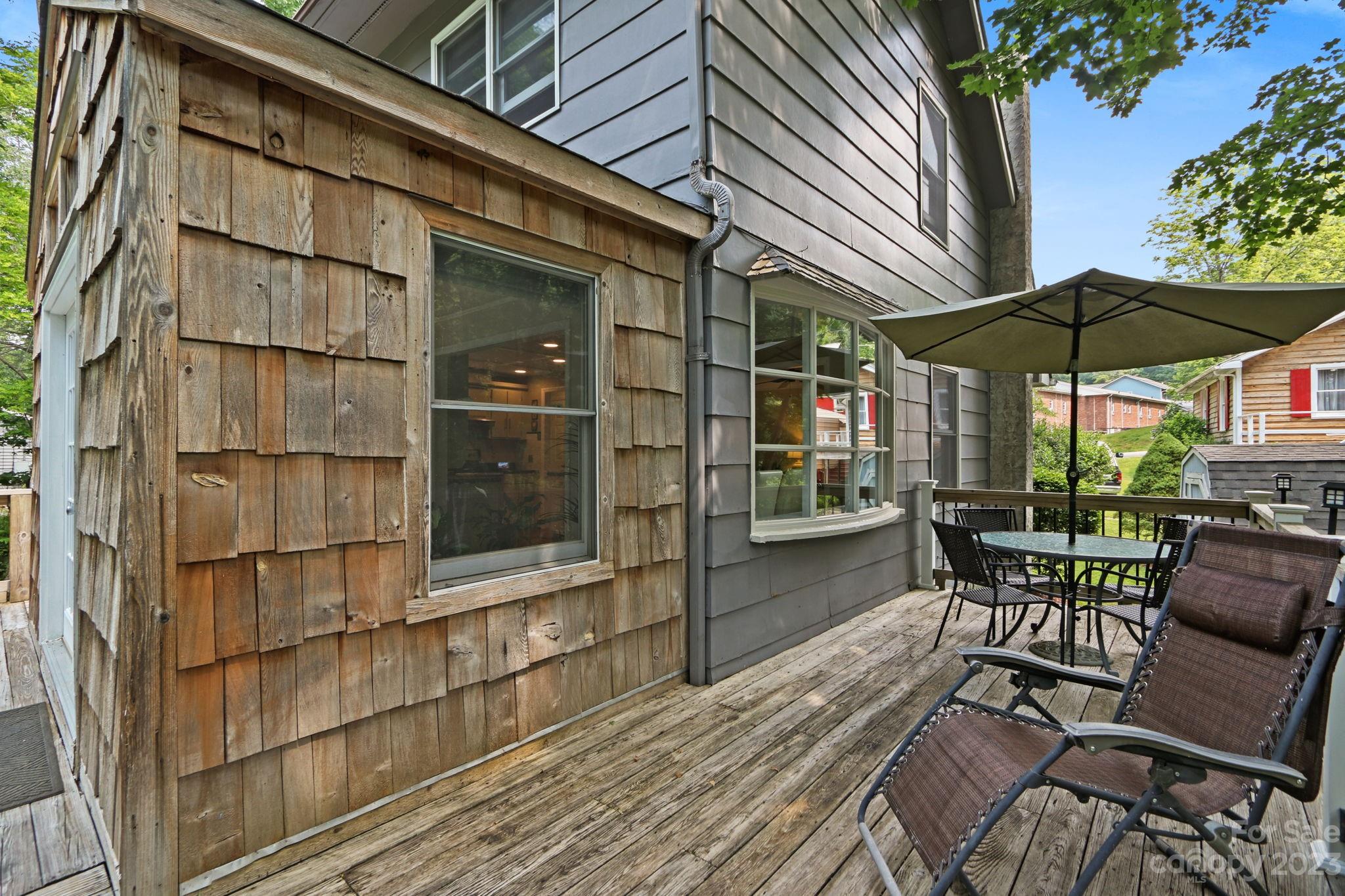 270 Pine Street Boone, NC 28607 - Photo 20 of 47 a view of a patio with table and chairs under an umbrella