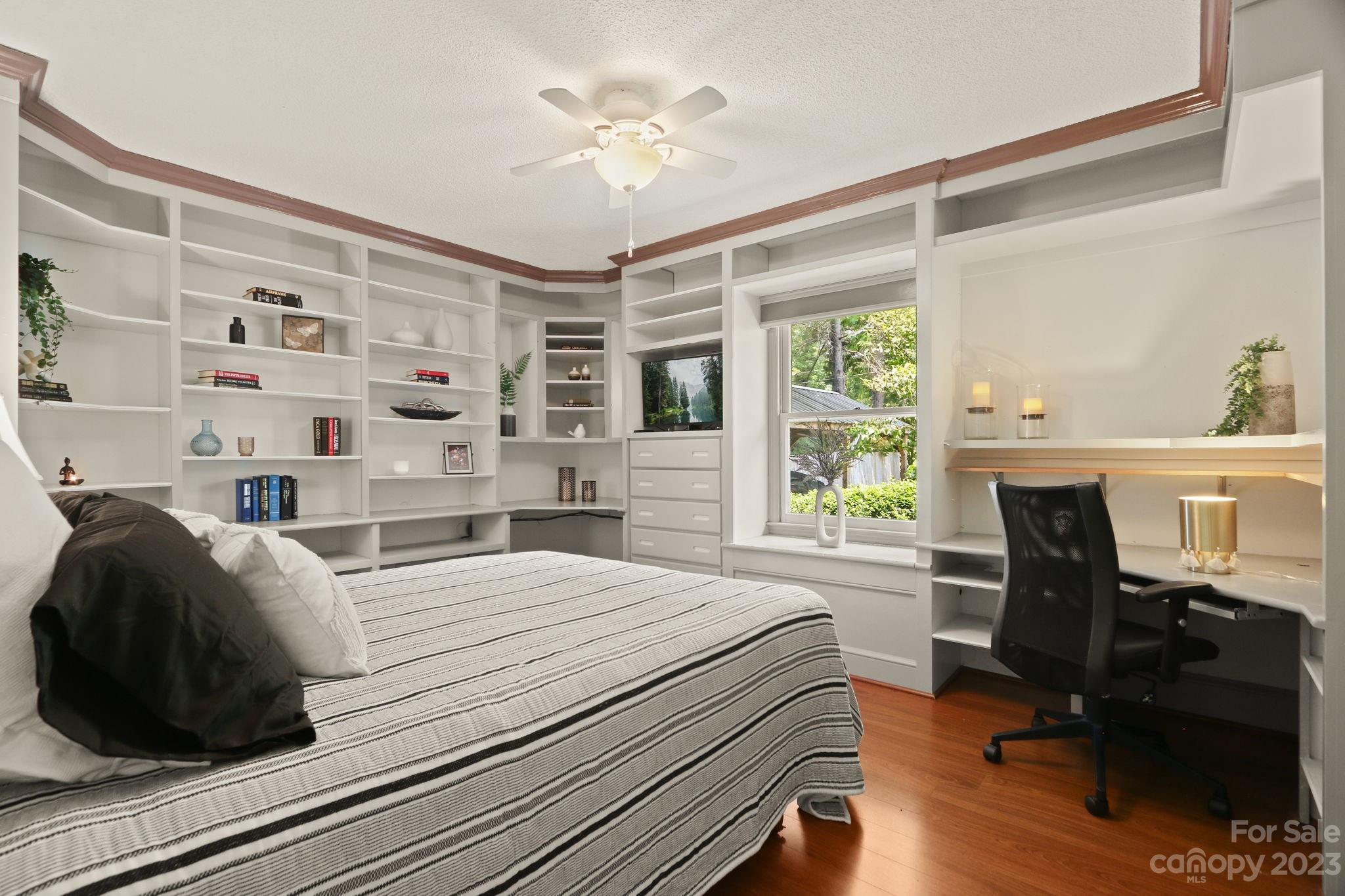 270 Pine Street Boone, NC 28607 - Photo 21 of 47 a bedroom with a bed a desk and chair with the wooden floor