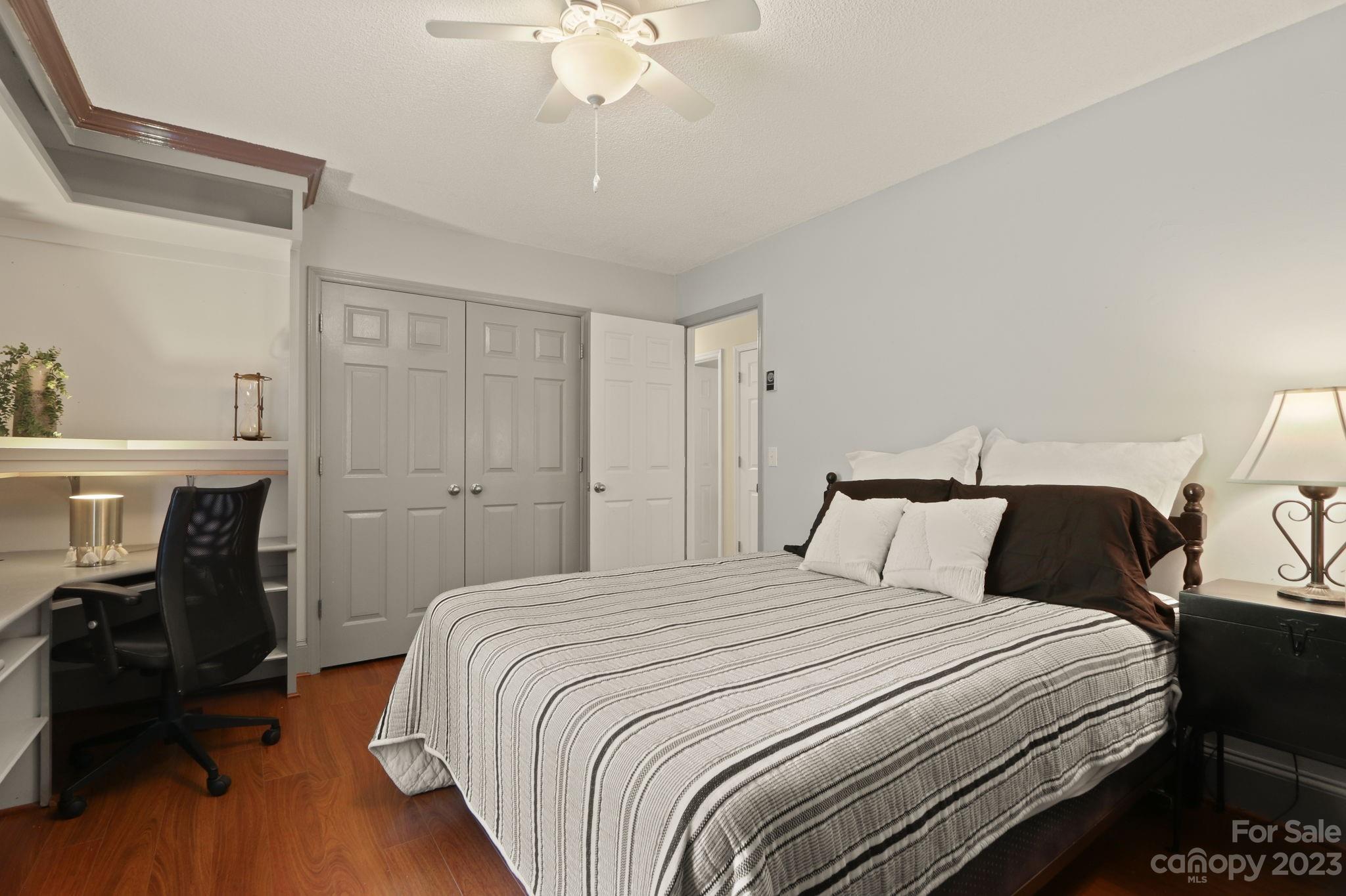270 Pine Street Boone, NC 28607 - Photo 22 of 47 a bedroom with a bed and a chandelier