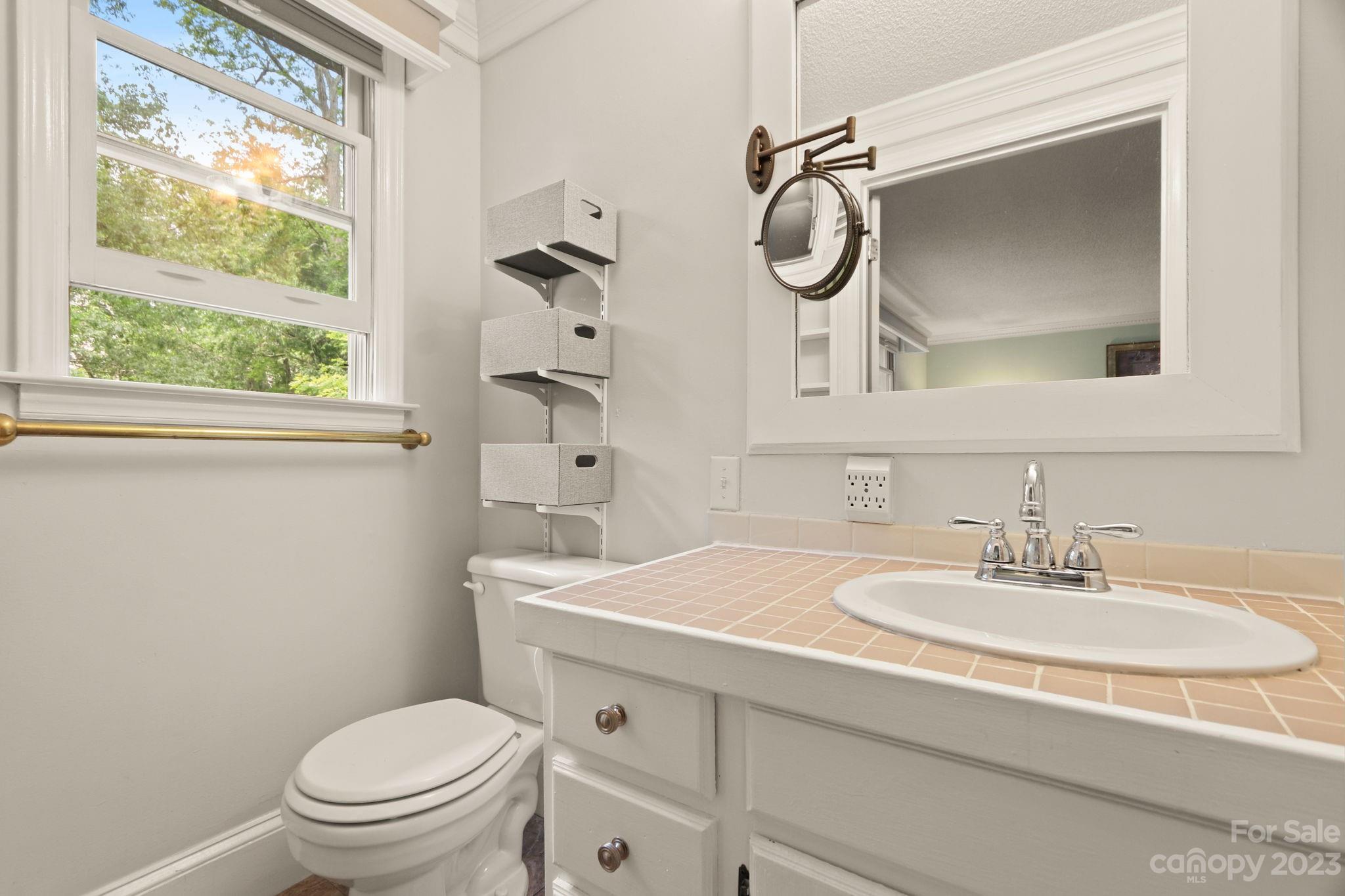 270 Pine Street Boone, NC 28607 - Photo 30 of 47 a bathroom with a sink a toilet and a mirror