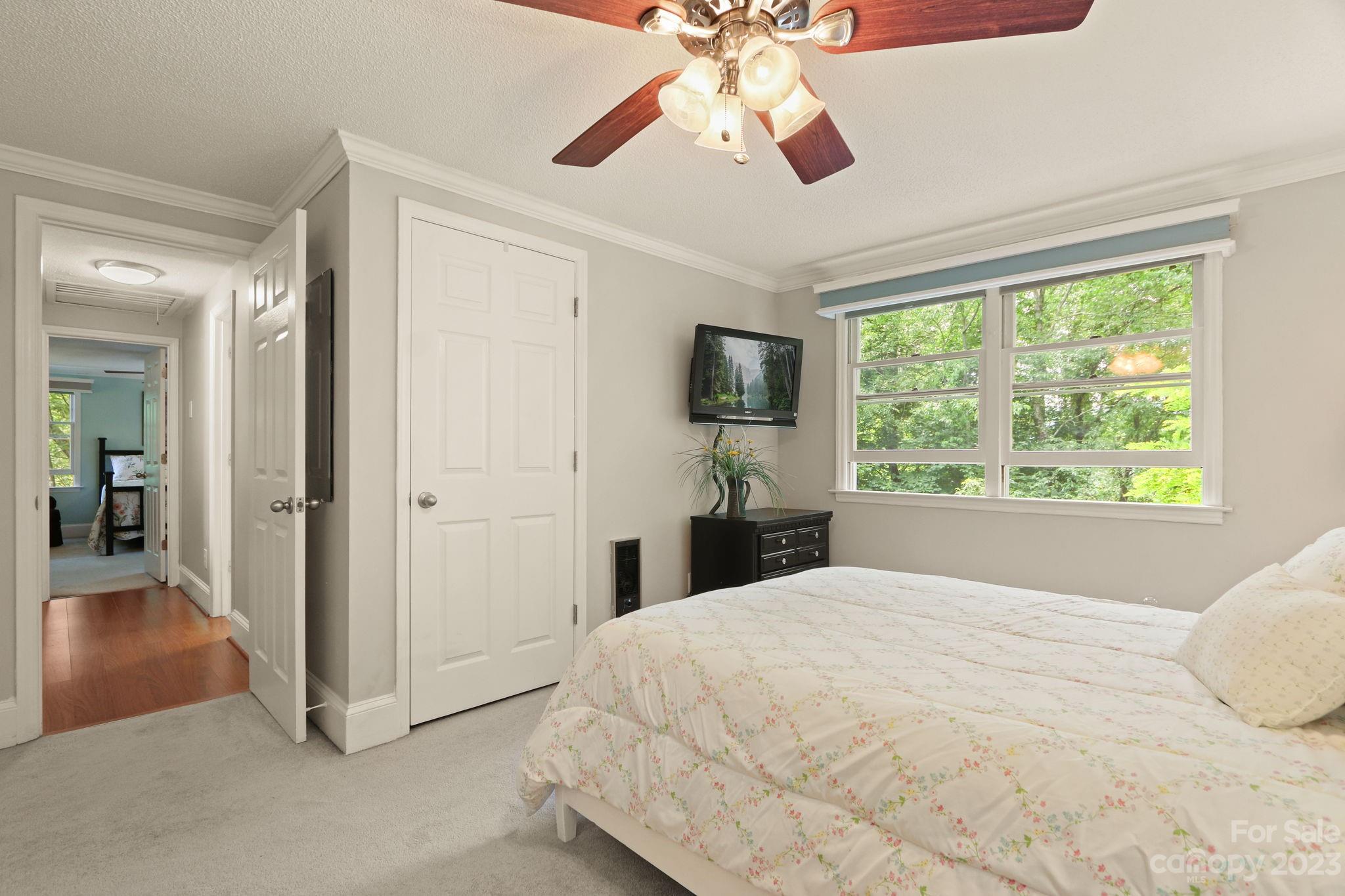 270 Pine Street Boone, NC 28607 - Photo 34 of 47 a spacious bedroom with a large bed and a chandelier